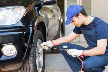 Poster - Mechanic inflating a tire