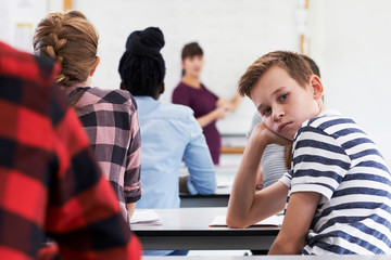 Wall Mural - portrait of bored teenage pupil in class
