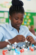 © highwaystarz - Female Pupil Using Molecular Model Kit In Science Lesson