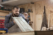 © 1001color - Wood designer working in workshop.