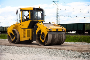 A road roller on the road.