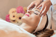 Beautiful woman relaxing during rejuvenating facial massage in a modern beauty center
