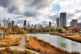 Fototapeta Miasta - Urban cityscape and modern architecture background.Chicago downtown skyline from Lincoln Park Neighborhood located at the Lincoln Park Zoo. Autumn cityscape with cloudy sky over skyscrapers. 