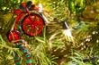 A toy bicycle decoration hangs from a Christmas tree.