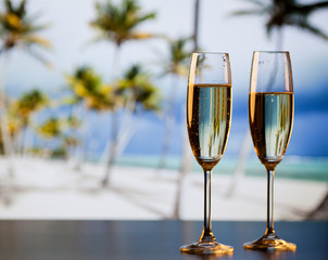 Wall Mural - two champagne glasses on the beach - exotic New Year