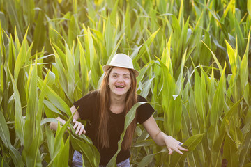 40 yo woman in corn. Smiling woman with a hat in corn at sunset