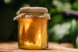 Fototapeta  - organic honey with honeycomb in glass jar