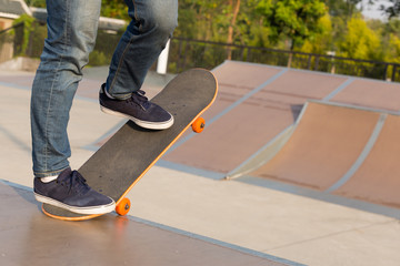 Wall Mural - skateboarder legs skateboarding on skatepark ramp