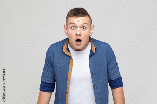 Boy open mouth scream and have a big eyes.