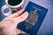 Hand holding a canadian passport
