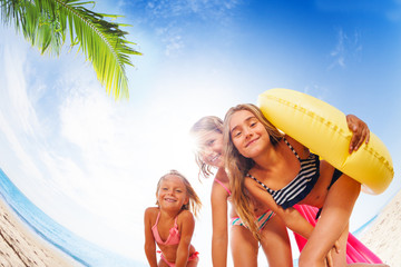 Wall Mural - Happy girls having fun on exotic beach in summer