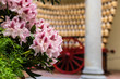 Pink flowers with cart and Chianti bottles.