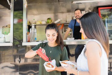 Wall Mural - Eating hot dogs from food truck