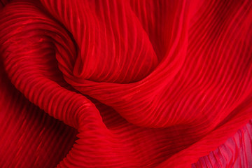 the texture of the pleated fabric. red georgette fabrics.