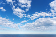 Blue Cloud Sky Against Blue Sea Horizon