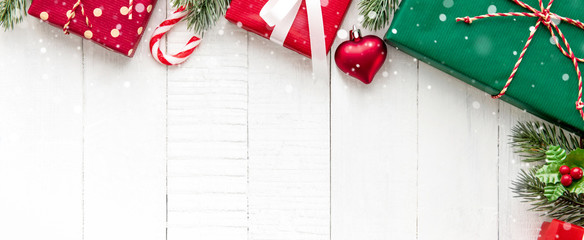 christmas gift boxes with decorating ornaments on white wood background border design