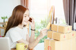 © jumlongch - Young asian girl is freelancer with her private business at home office, working with laptop, coffee, online marketing, Customer order and packaging or packing.