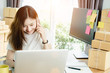 © jumlongch - Young asian girl is freelancer with her private business at home office, working with laptop, coffee, online marketing, Customer order and packaging or packing.