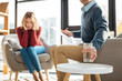 © zinkevych - Psychologists office. Selective focus of a glass of water being put on the table by a nice handsome male psychologist while working with a patient