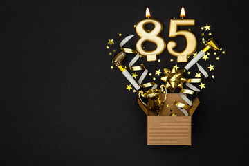 Wall Mural - Number 85 gold celebration candle and gift box background