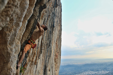 climber working to the top of difficult climb on Majorca