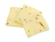 Three squares of fresh pepper jack cheese isolated on a white background.