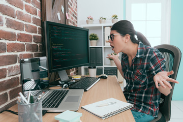 beautiful programmer woman looking at computer