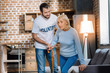 © Viacheslav Yakobchuk - Not hurry. Calm tired elderly woman standing up slowly with a help of her qualified social worker while spending time with him at home