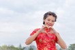 © reewungjunerr - happy Chinese new year. Asian woman wearing traditional Cheongsam clothes portrait outdoor