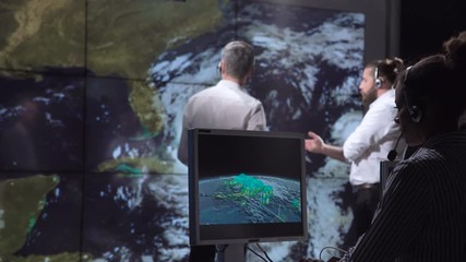 group of scientists investigating hurricane as consequence of global warming on earth. elements of t