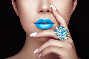 Wall Mural - Beauty Fashion woman lips with natural Makeup and white Nail polish. Gloss Blue Lipstick. Beauty girl face close up. Sexy Lips, Manicure, Make up. Ring with Precious Stones, Jewelry