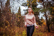 © maryviolet - Young woman running in autumn forest