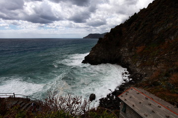 waves crashing on the rocky coast of northern Italy f