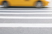 Abstract Blur Of Urban Street Scene With A Yellow Taxi Cab In New York, United States