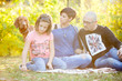 © DC Studio - Happy family on the grass in park playing with their dog. Animal lovers