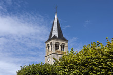 France, Cormatin: Steeple With Tower Clock, Green Trees And Blue Sky