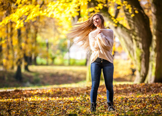 Wall Mural - Enjoy autumn happy woman on colorful fall background