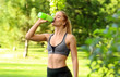 © Africa Studio - Sporty young woman drinking water in park