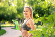 © Africa Studio - Sporty young woman with bottle of water in park
