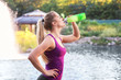 © Africa Studio - Sporty young woman drinking water on riverside