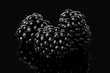 Ripe blackberry berries lie on a black background