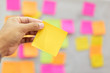 © arcyto - Close up hand holding empty note sticky for brainstorm strategy workshop business.Brainstorming concept.