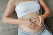 © zilvergolf - Pregnant Woman hands in a heart shape on her belly.