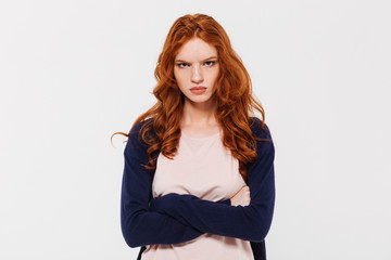 angry pretty young redhead lady with arms crossed.