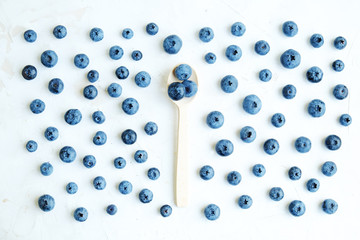 Wall Mural - Freshly picked blueberries on white, spoon with blueberry . Flat lay.