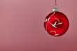 Red christmas bauble on pink background