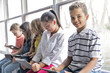 © Louis-Paul Photo - Group of curious children watching stuff on the tablet screen