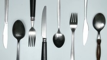 Moving Cutlery On White And Red Background. Cooking Jingle Concept. Stop Motion Animation.
