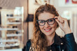 © bnenin - View of a young attractive woman testing new glasses.