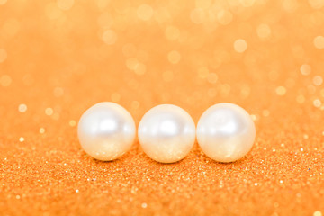 Wall Mural - Pile of pearls on golden christmas background